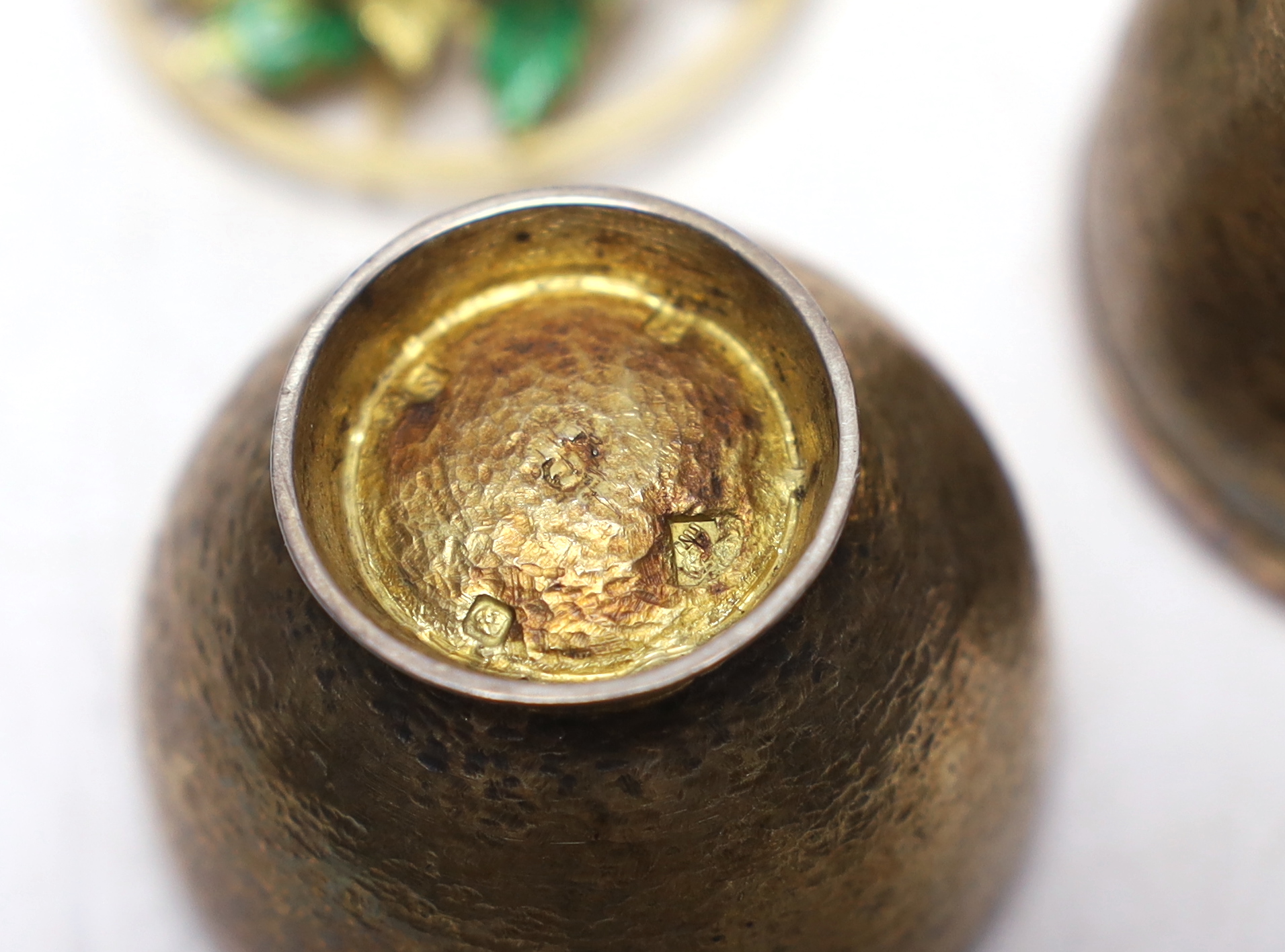 An Elizabeth II silver gilt surprise egg, in the manner of Stuart Devlin, maker possibly Algernon Asprey?, opening to reveal an enamelled and diamond set scene of a ladybird upon a flower, London, 1973, 79mm.